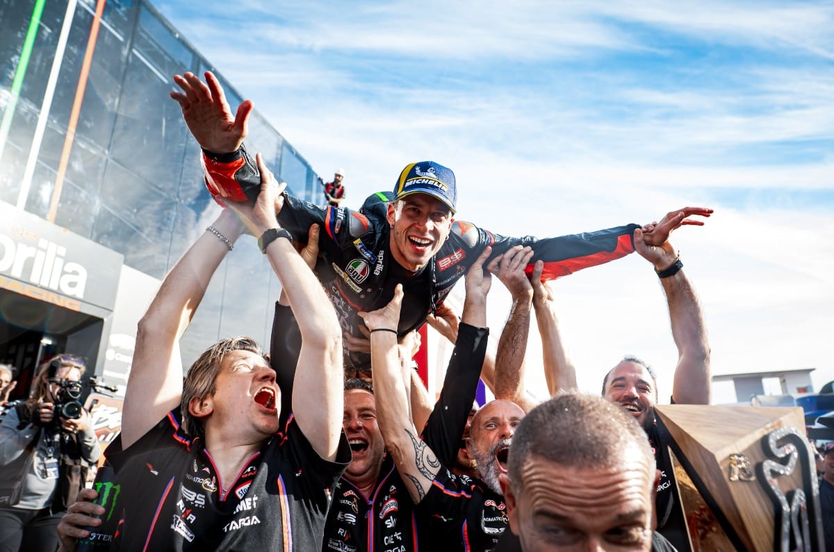 Marco Bezzechhi celebrating with Aprilia team after MotoGP race
