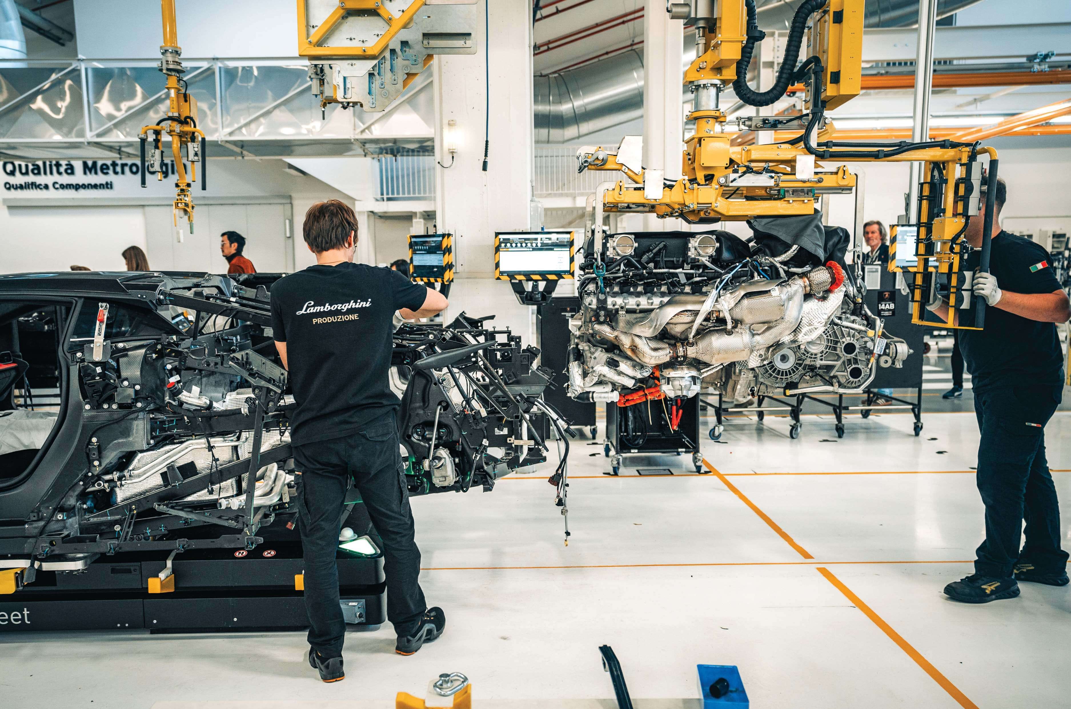 Engine being fitted into a Lamborghini car