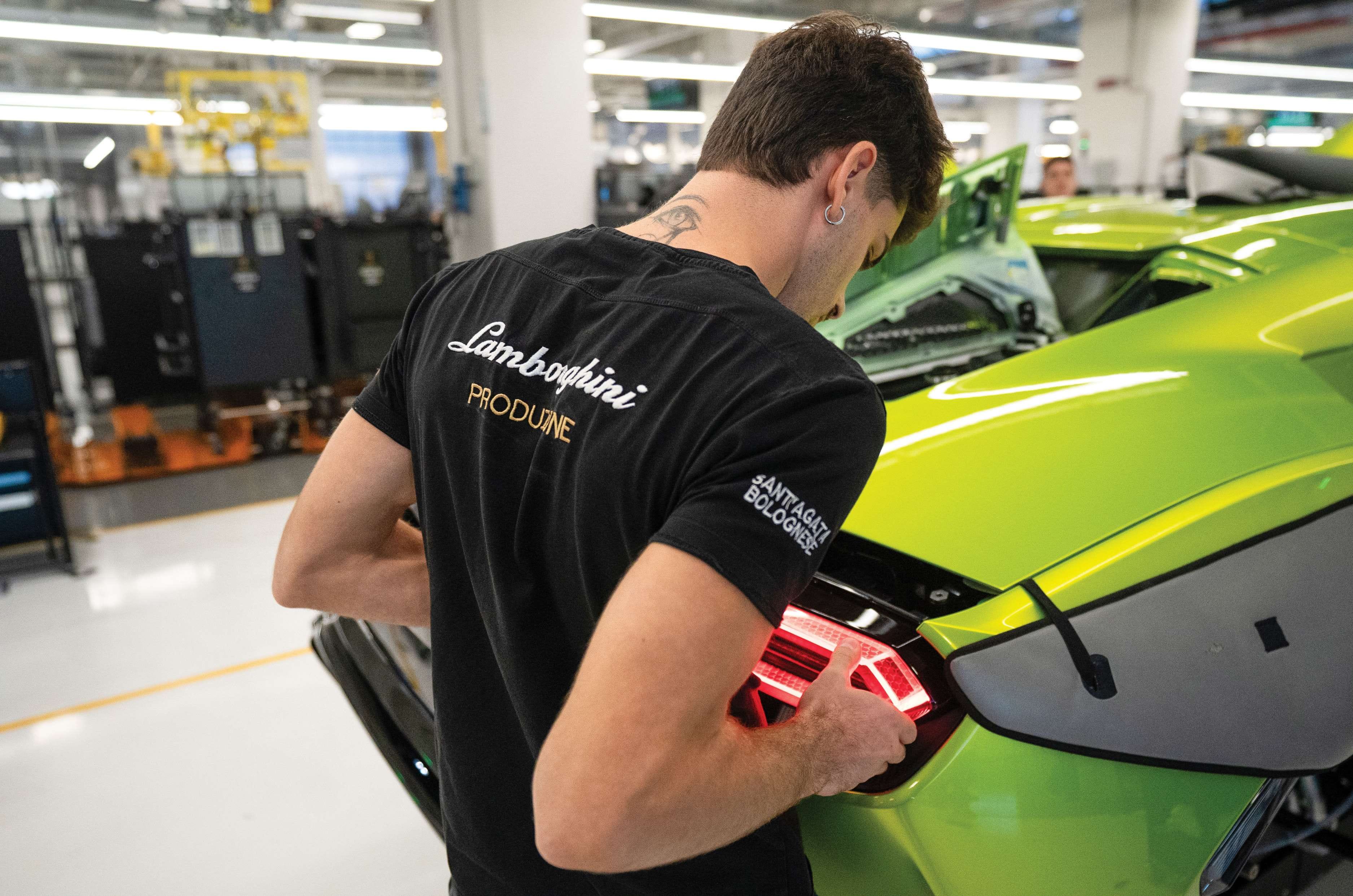 Technician fitiing a taillight on a Lamborghini car
