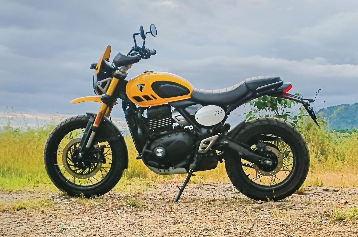 Triumph Scrambler 400 XC left side profile static in field