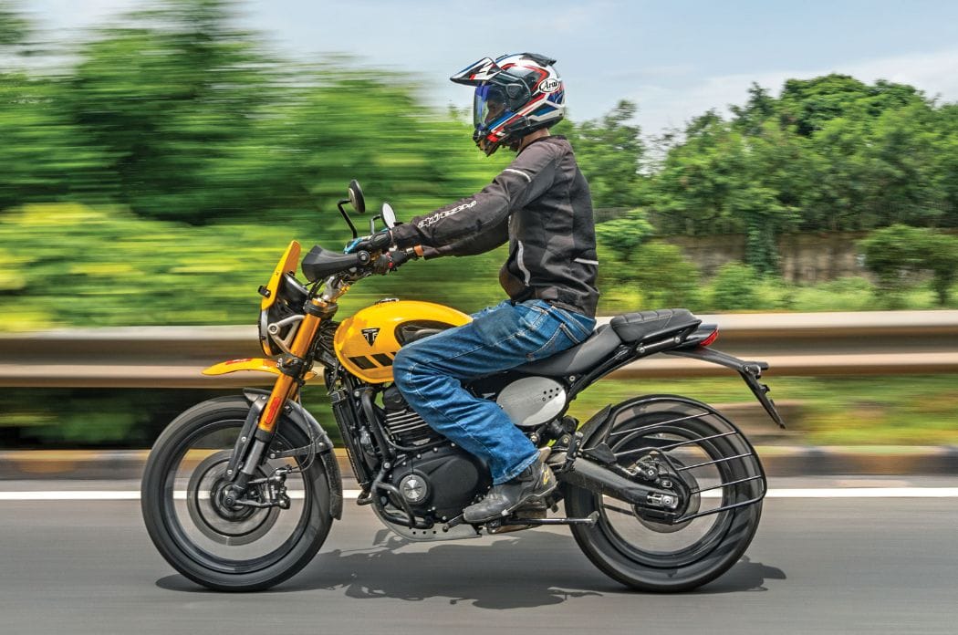 Triumph Scrambler 400 XC left side profile riding shot on road