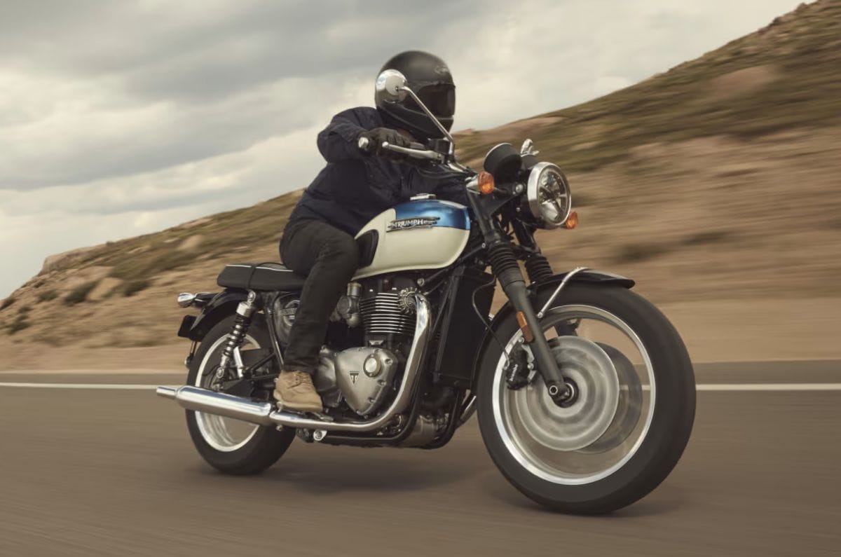 Triumph Bonneville T120 front right side riding shot on road
