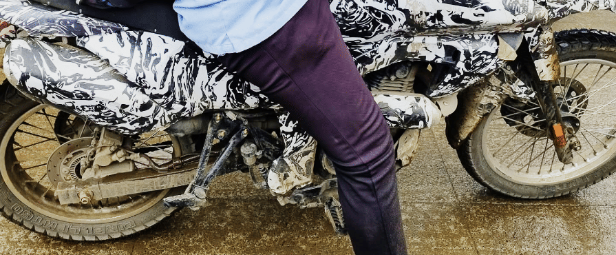Upcoming Bajaj dual-sport right side showing the exhaust and wheels