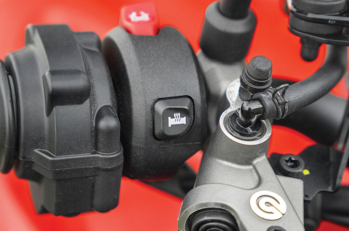 A close up shot showing the heat grips button on the Ducati Monster V2's front right switch cube