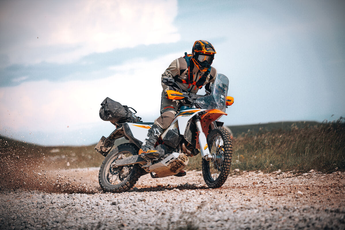An action shot of a rider drifting on the KTM 690 Rally