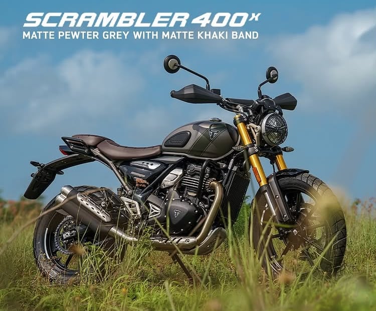 An outside showing the Triumph Scrambler 400 X in the new Matt pewter grey/Matt khaki green colour