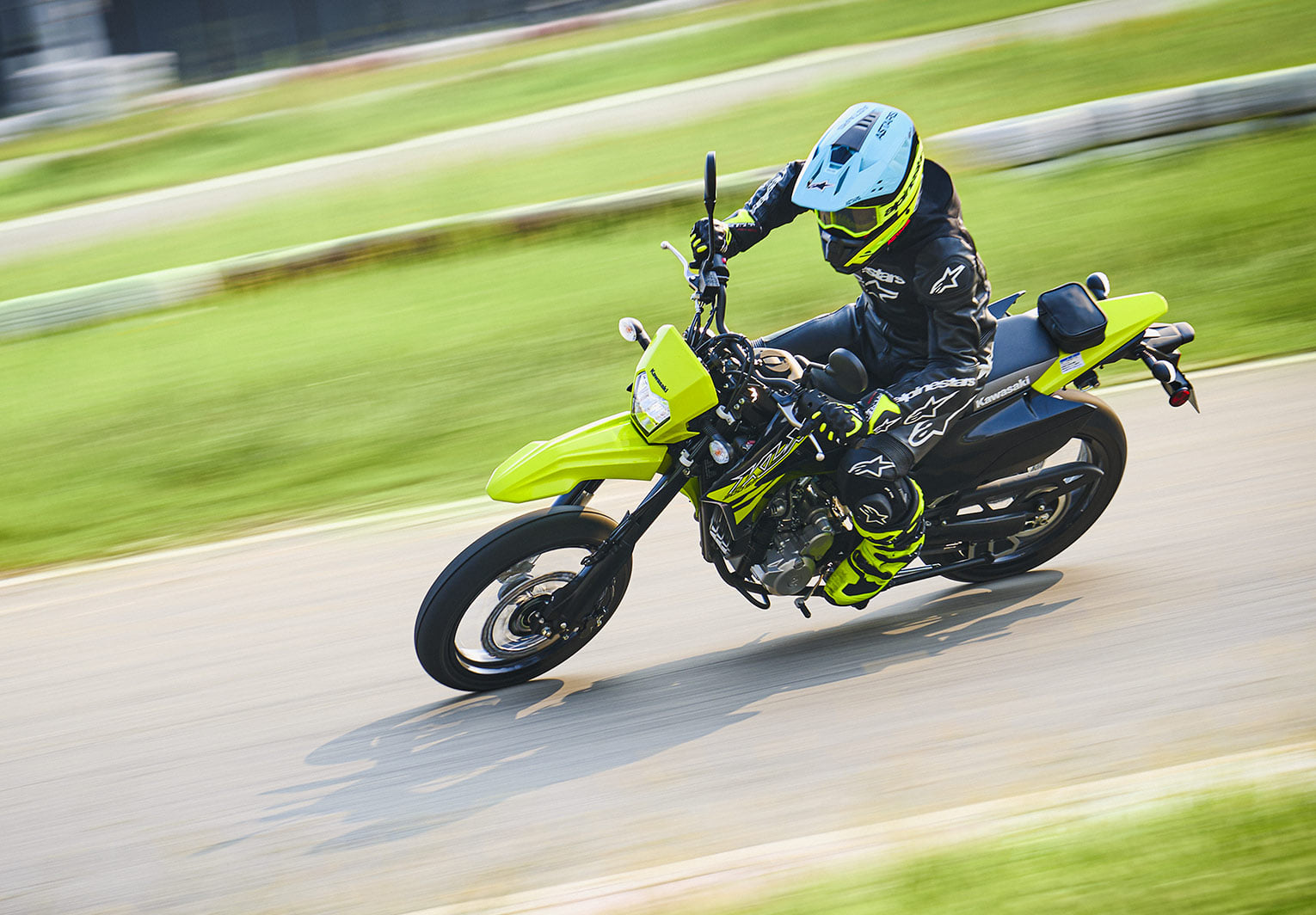 Rider performing a left leaning turn on the 2027 Kawasaki KLX300 SM.