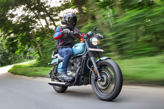 Rider cruising on a Yezdi Roadster