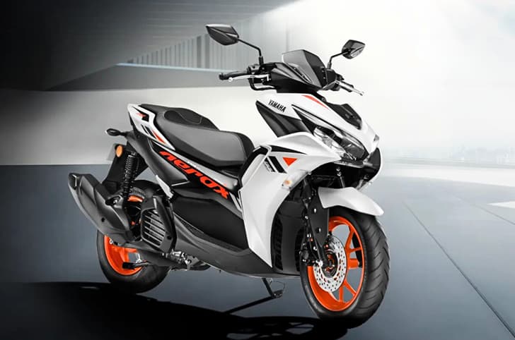 Yamaha Aerox ice fluo vermillion front right side static in parking lot