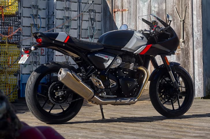 Triumph Thruxton 400 black rear right side static image at shipping dock