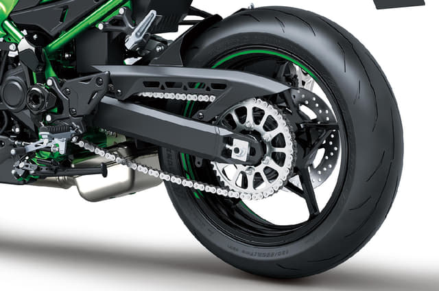 Close up of Kawasaki Z900 rear tyre, sprocket, and swingarm