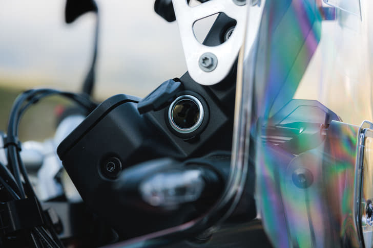 A close up shot of the 12V charging port on the KTM 690 Rally