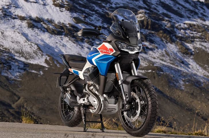 Outside image showing the Moto Guzzi Stelvio's front right three quarter in Duecento Tributo colour.