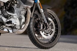Close up outside shot showing the Moto Guzzi Stelvio's 19-inch front wheel and twin 320mm discs and Brembo monobloc radial calipers.