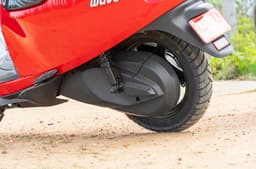 An outside close up shot showing the Wave's rear wheel hub and the enclosed chain drive.