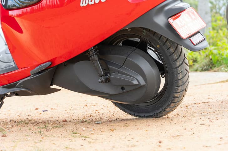 An outside close up shot showing the Wave's rear wheel hub and the enclosed chain drive.