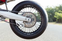 An outside close up image showing the Ducati Desmo450 SM's race slick tyres from Metzeler Racetec.