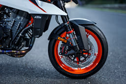 An outside close up image showing the KTM 990 Duke R's front USD fork and 320mm diameter dual discs.