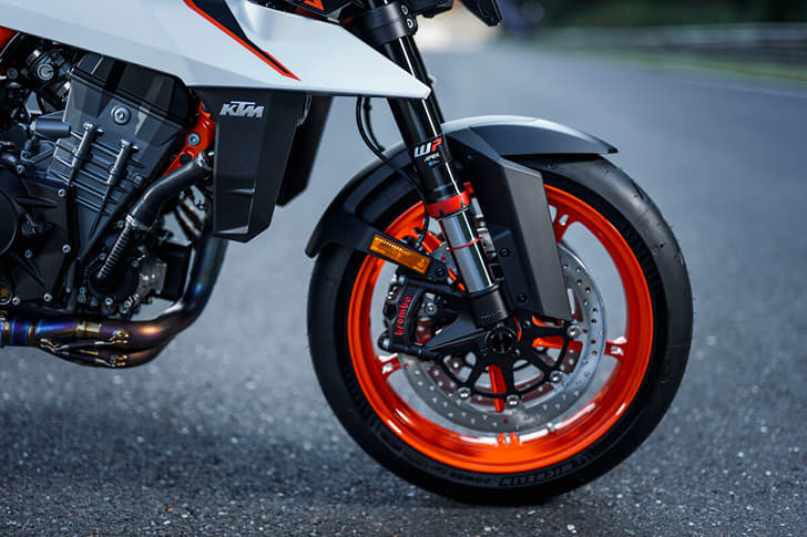 An outside close up image showing the KTM 990 Duke R's front USD fork and 320mm diameter dual discs.