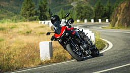 Outside image showing the Yamaha Tracer 7 in Redline colour.