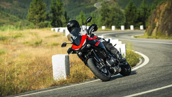 Outside image showing the Yamaha Tracer 7 in Redline colour.