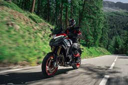 A rider sat astride the Multistrada V4 Pikes Peak, showing its front left quarter.
