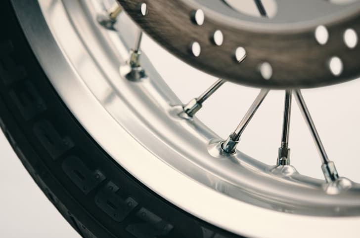 Close up of the Triumph Bonneville T40's silver-colours front wheel.
