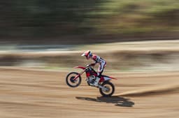 Rider performing a wheelie on the Desmo450 MX Factory.