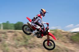 Rider performing a jump on the Desmo450 MX Factory.