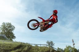Rider performing a jump on the Desmo450 MX.