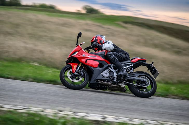 Rider performing a right leaning turn on the F 450 RR  at a racetrack, looking once again like the S 1000 RR.