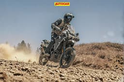 An outdoor shot of a rider performing a slide on the 2027 Kawasaki KLR650 DF