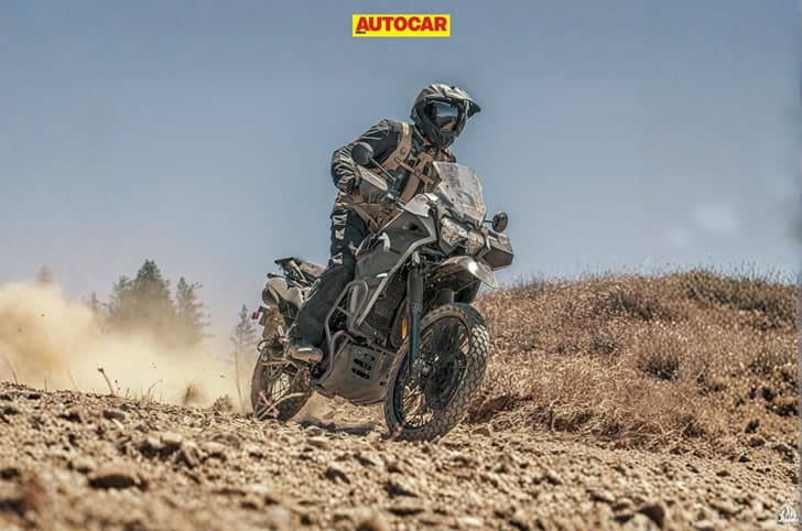 An outdoor shot of a rider performing a slide on the 2027 Kawasaki KLR650 DF