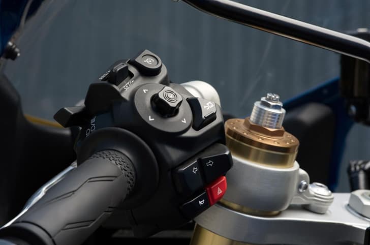 Close up of the left switch cube on the XSR900 GP, showing the cruise control switch and the adjustable USD fork.