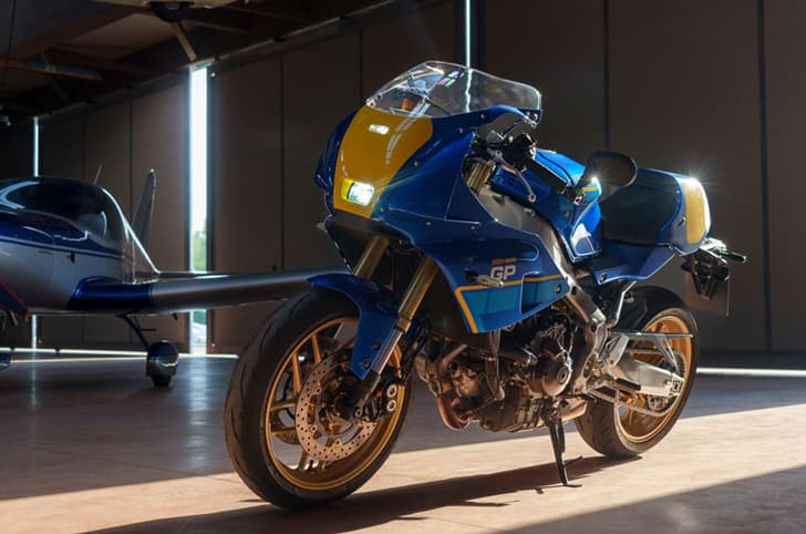 Inside shot of the Yamaha XSR900 GP Legend Blue with a small plane at the back.