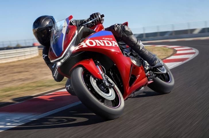 An outdoor shot of a rider cornering the Honda CBR500R Four
