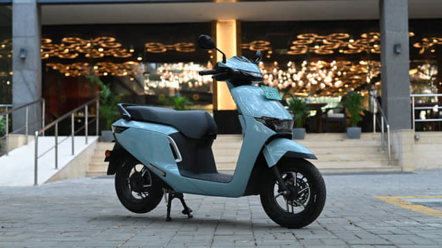 Activa e parked against a building with lights