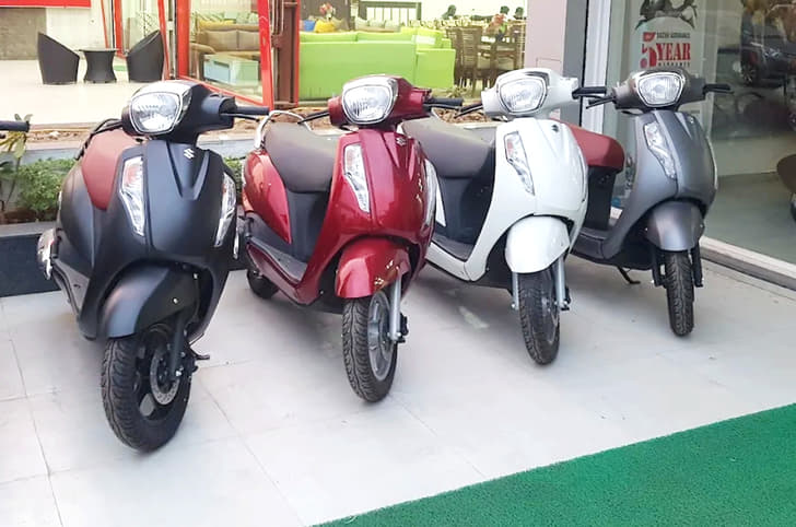 Suzuki Access scooters parked outside showroom in India