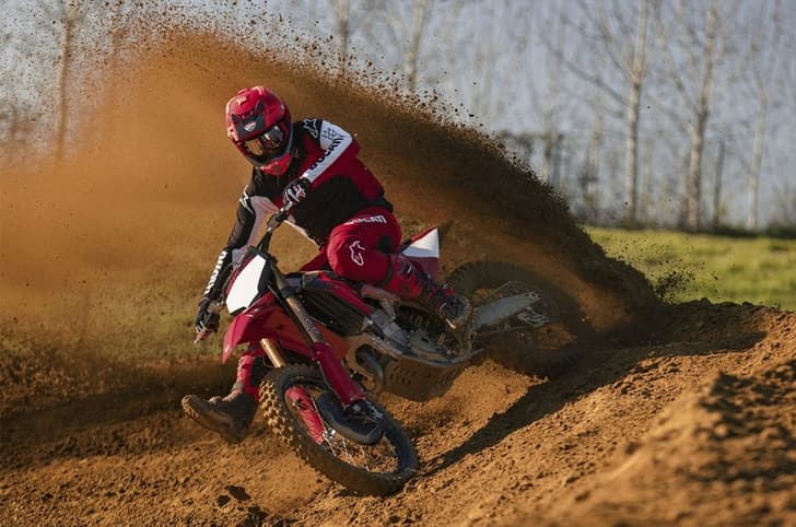 Ducati Desmo450 MX Factory sliding through dirt.