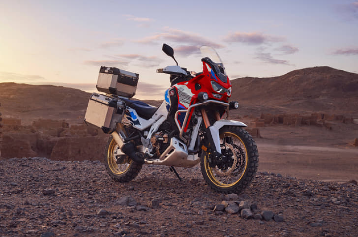 Static of 2026 Honda Africa Twin parked with gravel and mountains in the background 