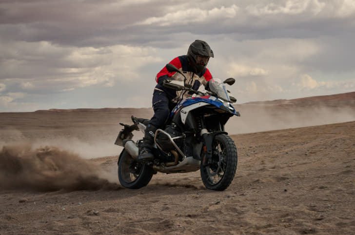 Rider power-sliding a R 1300 GS through sand