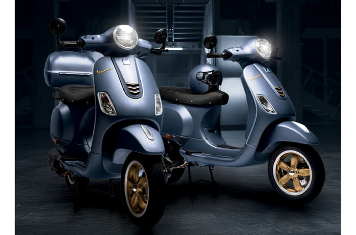 Two Vespa Officina 8 parked in a dimly lit room