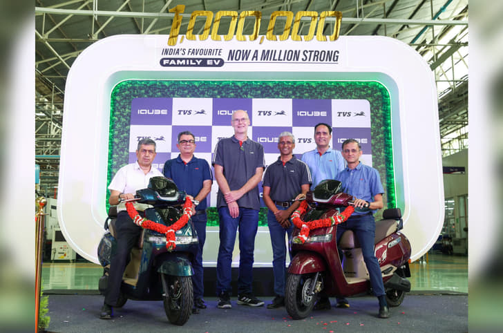 TVS team alongside two iQube scooters