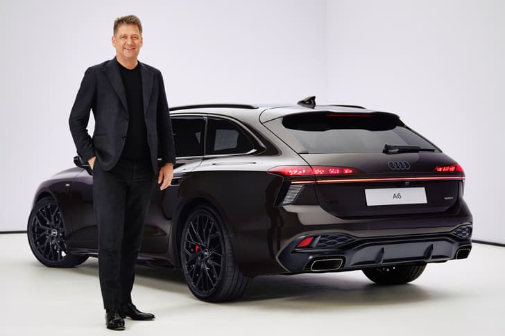 Audi CEO Gernot Dollner next to an A6 Avant