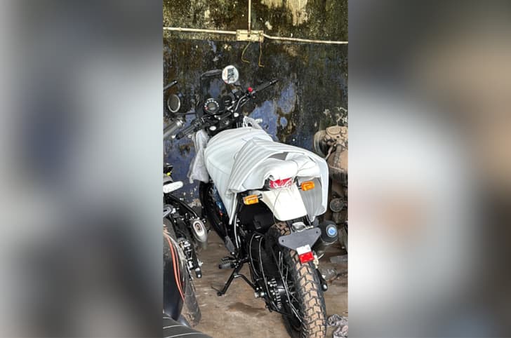 Outside image showing the rear left side of the Himalayan 440, parked at a showroom