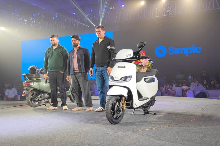 An indoor shot showing the new Wave scooter with the founders of Simple Energy on stage