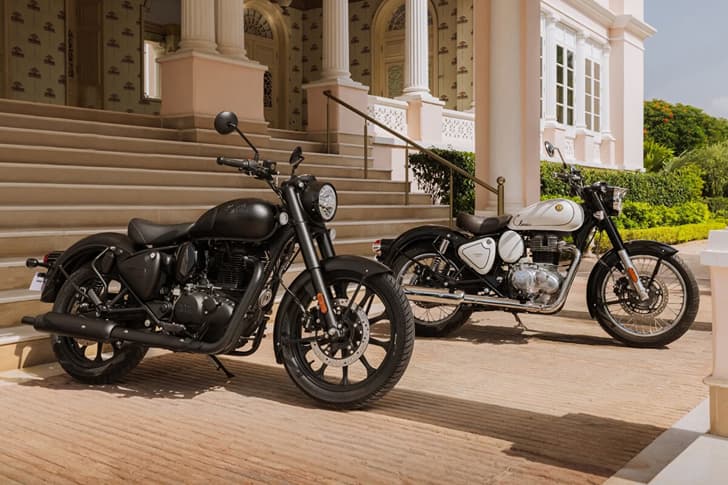 Two Royal Enfield Classic 350 bikes in front of a staircase
