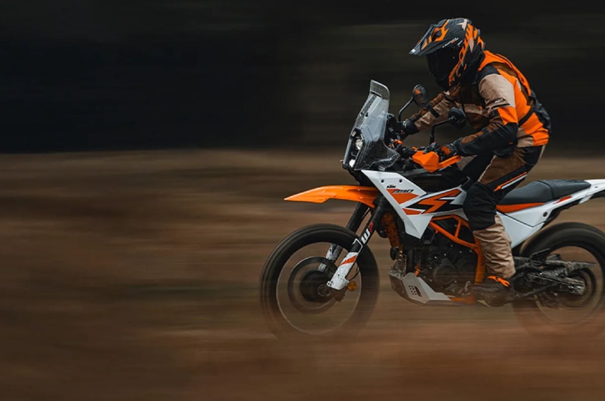 An outdoor shot of a rider standing of a KTM 390 Adventure R