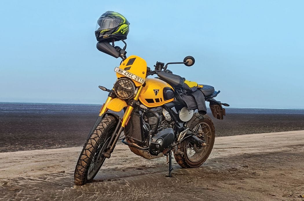 Triumph Scrambler 400 XC front left side static on beach
